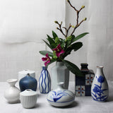 Small round white ceramic Japanese vase with blue grass design
