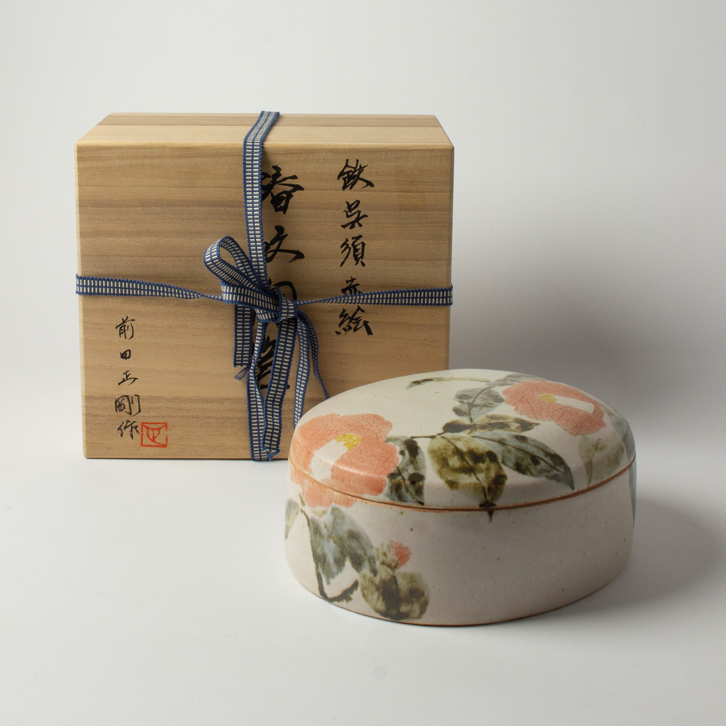 Japanese ceramic box with camellia motif by Seigō Maeda