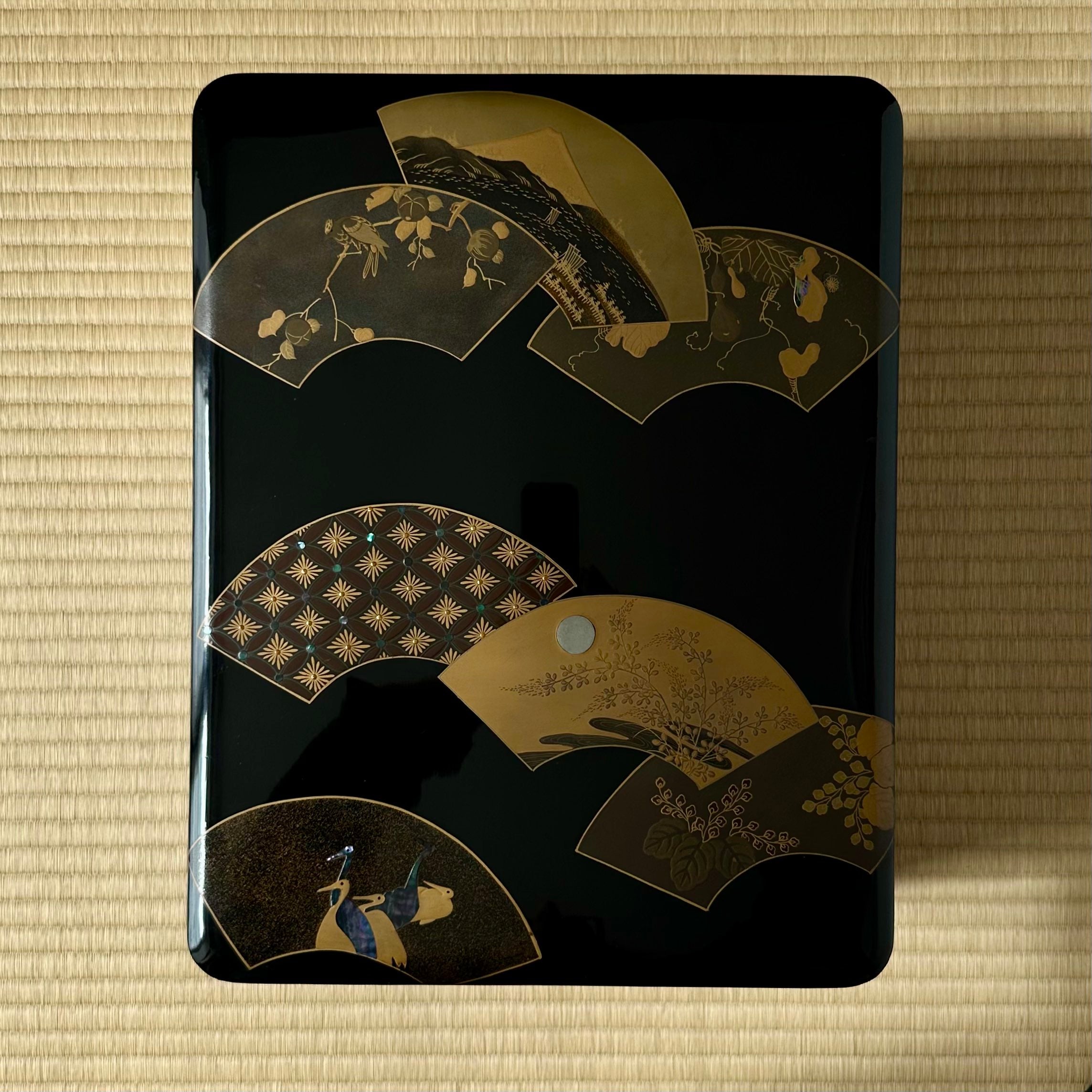 Bunkobako (Japanese document box) in urushi lacquer, gold, and mother-of-pearl, decorated with ōgi mon (fan motifs) and tsuru (cranes)